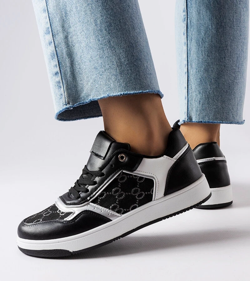 Schwarze Sneakers verziert mit Isidoras Monogramm